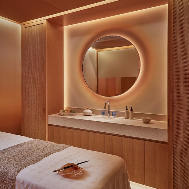 Surrenne treatment room featuring bed, basin, mirror and Surrenne products