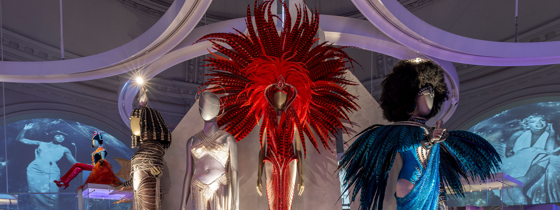 Mannequin in red feather and sequin outfit in V&A exhibition