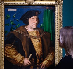 woman looking at painting by Hans Holbein