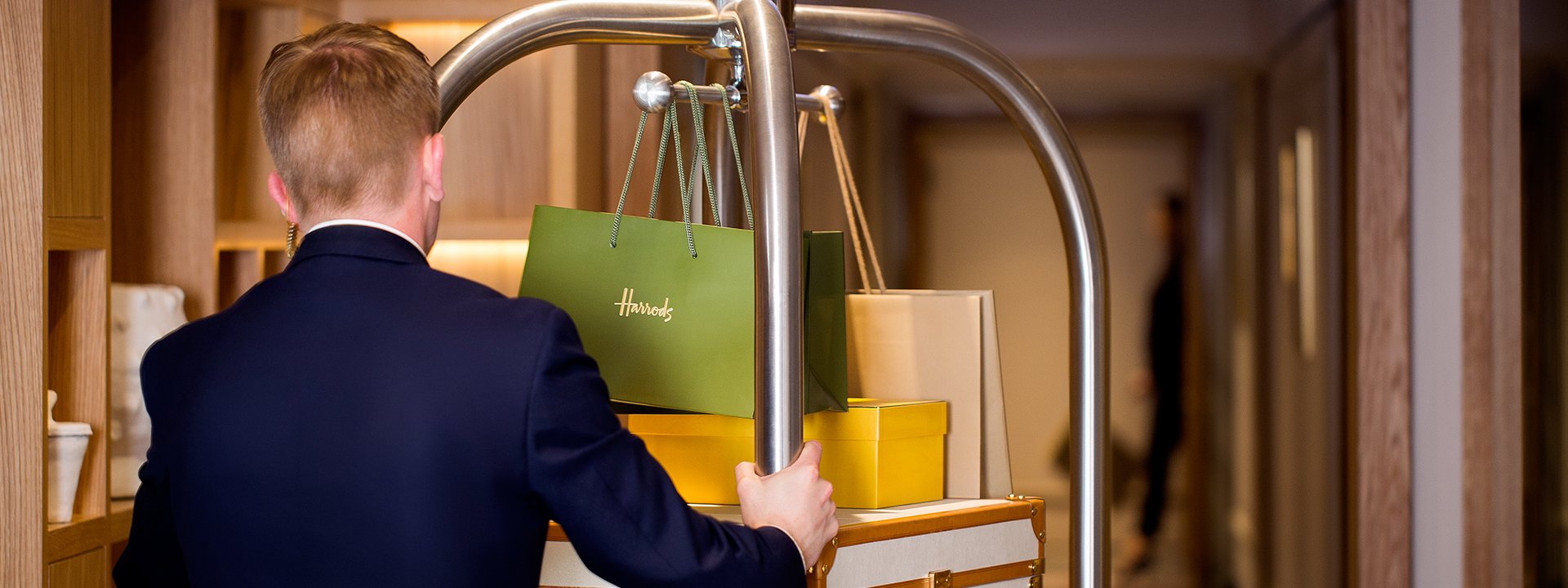 A staff concierge takes a hotel guest's luggage at The Berkeley to their room.