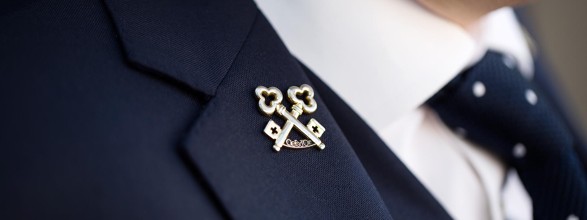 Display of a navy blue tie and suit from the concierge at The Berkley Hotel.