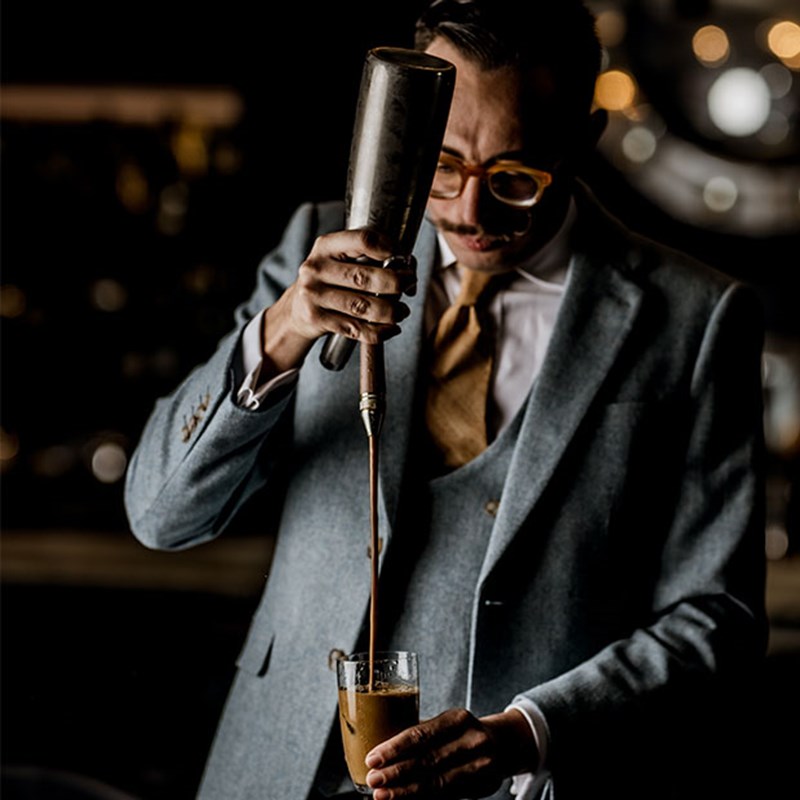 Marcello mixing a cocktail in the blue bar