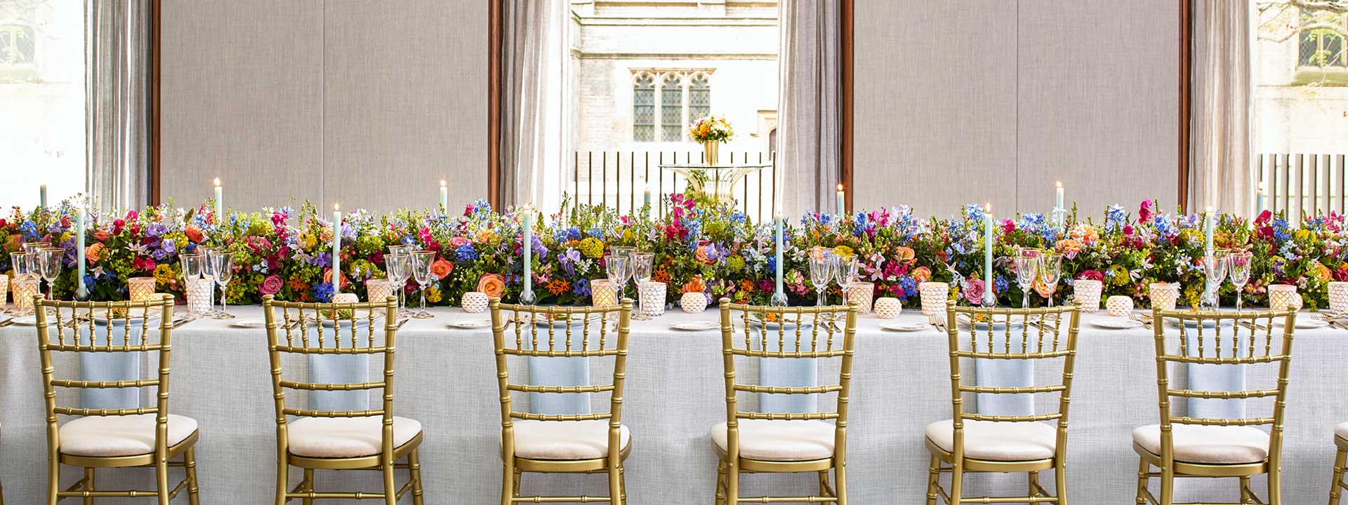 Colourful flower arrangements on the table and candle decoration create a romantic atmosphere in the Belgravia Room.