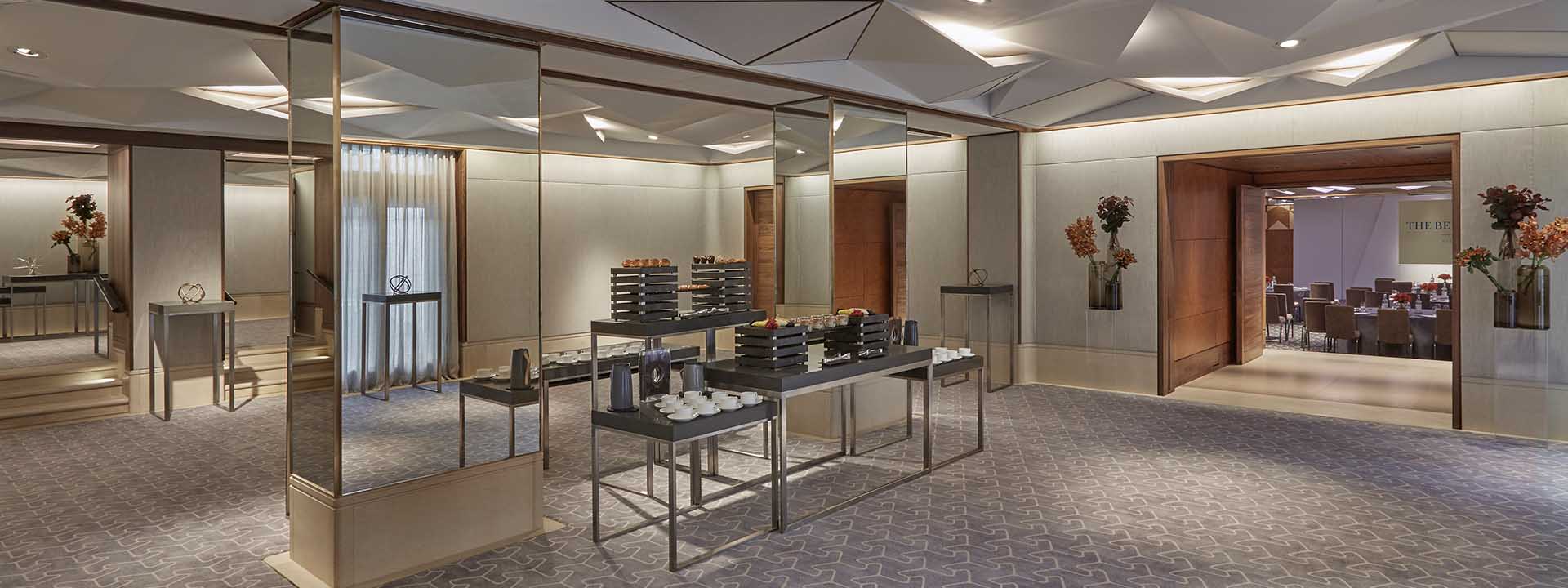The buffet is ready in one of the rooms in the modern interior with mirrors in the Belgravia Room.
