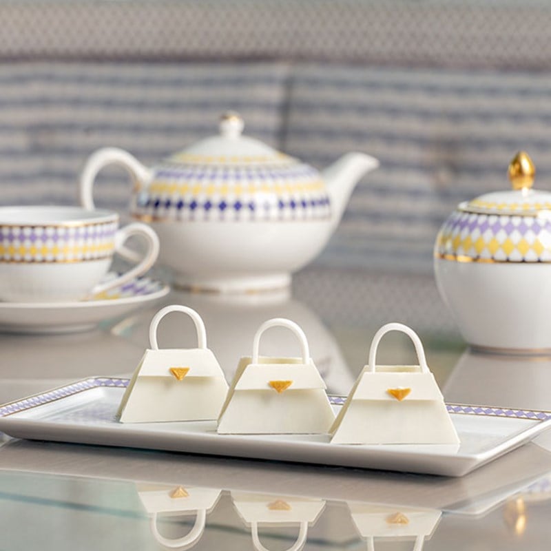 Three handbag-shaped biscuits on plate
