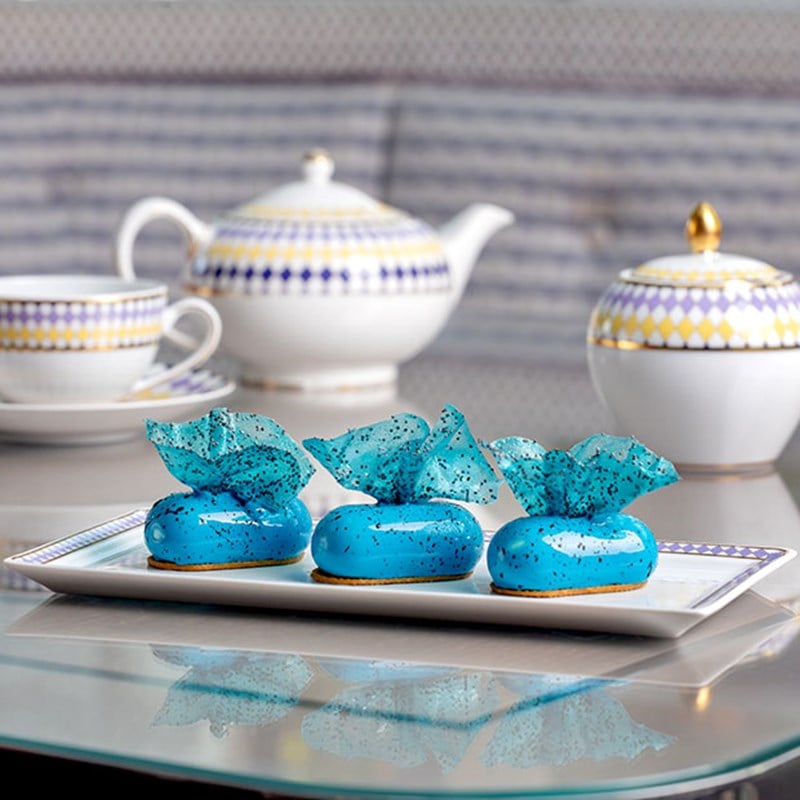 Three blue cakes on a plate