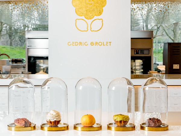 5 signature Cedric Grolet cakes from the Spring collection, featured in individual glass domes