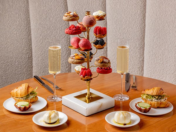 Tiered patiserrie, croissant sandwiches and two glasses of champagne