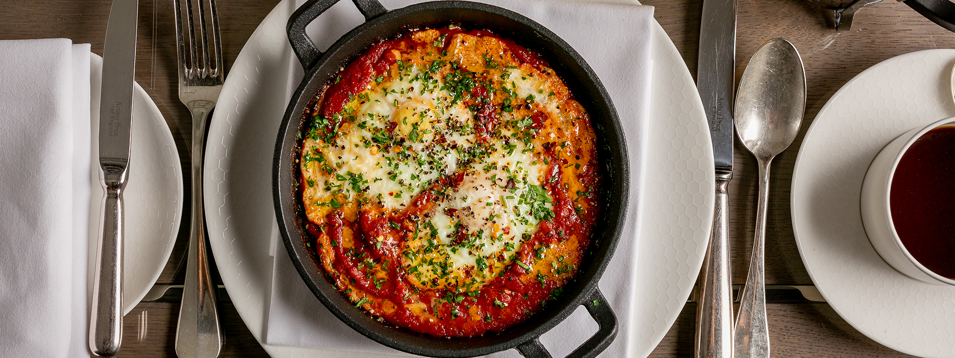 Shakshuka, a hot dish with aromatic tomato sauce that can be ordered for breakfast in the Collins Room.