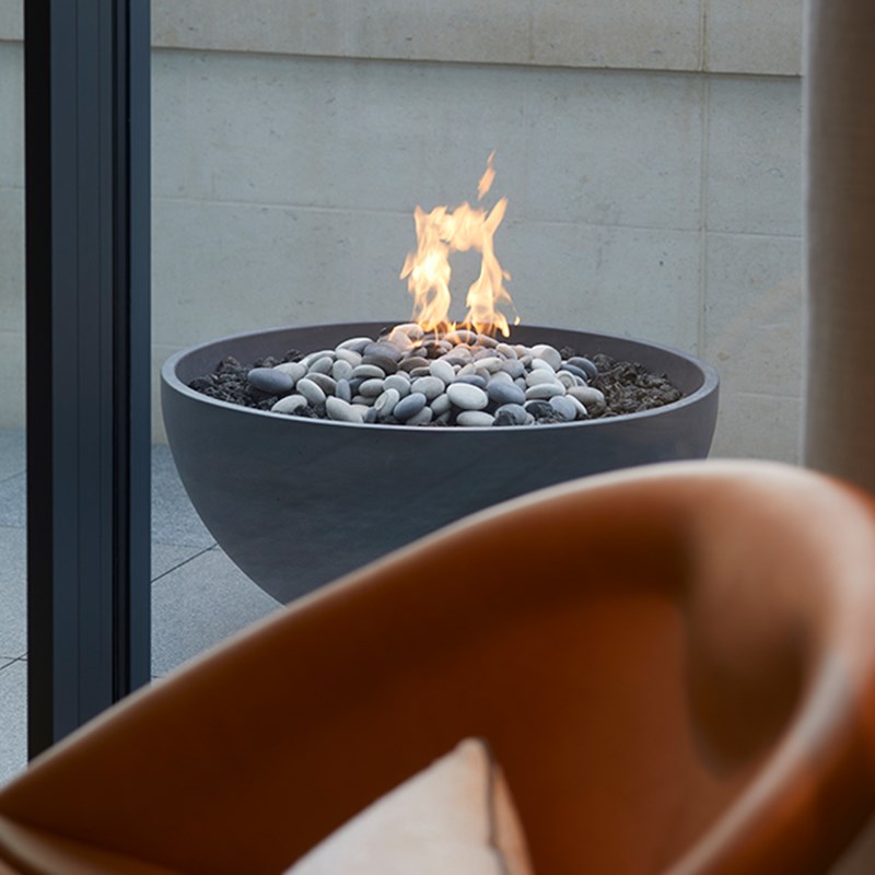 Edge of lounge chair and firepit on terrace of Hyde Park Penthouse