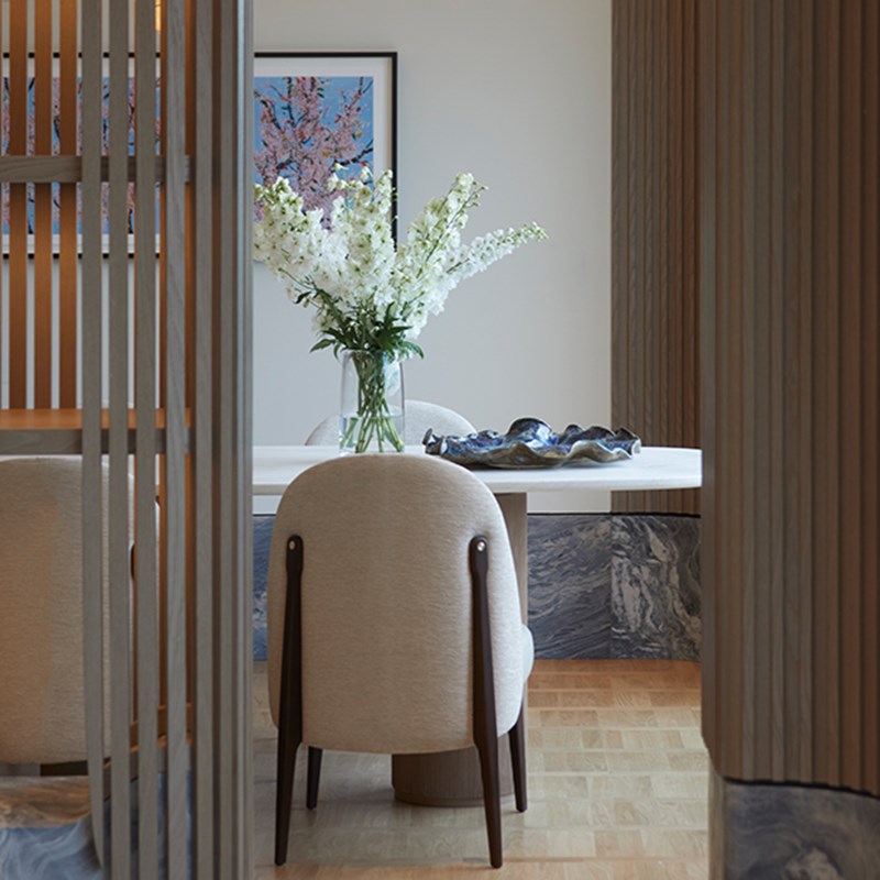 Back of cream dining chair and cream dining table in Hyde Park Penthouse