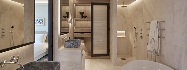 Large cream slate ensuite bathroom off of master bedroom with bath, rainfall shower and dual basin sinks