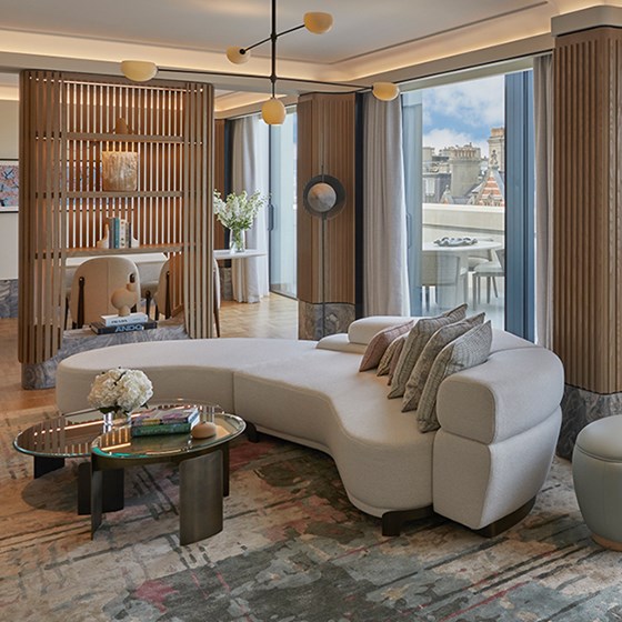 Hyde Park Penthouse at The Berkeley - view of the lounge with couch and coffee table, and dining room and terrace in the background.