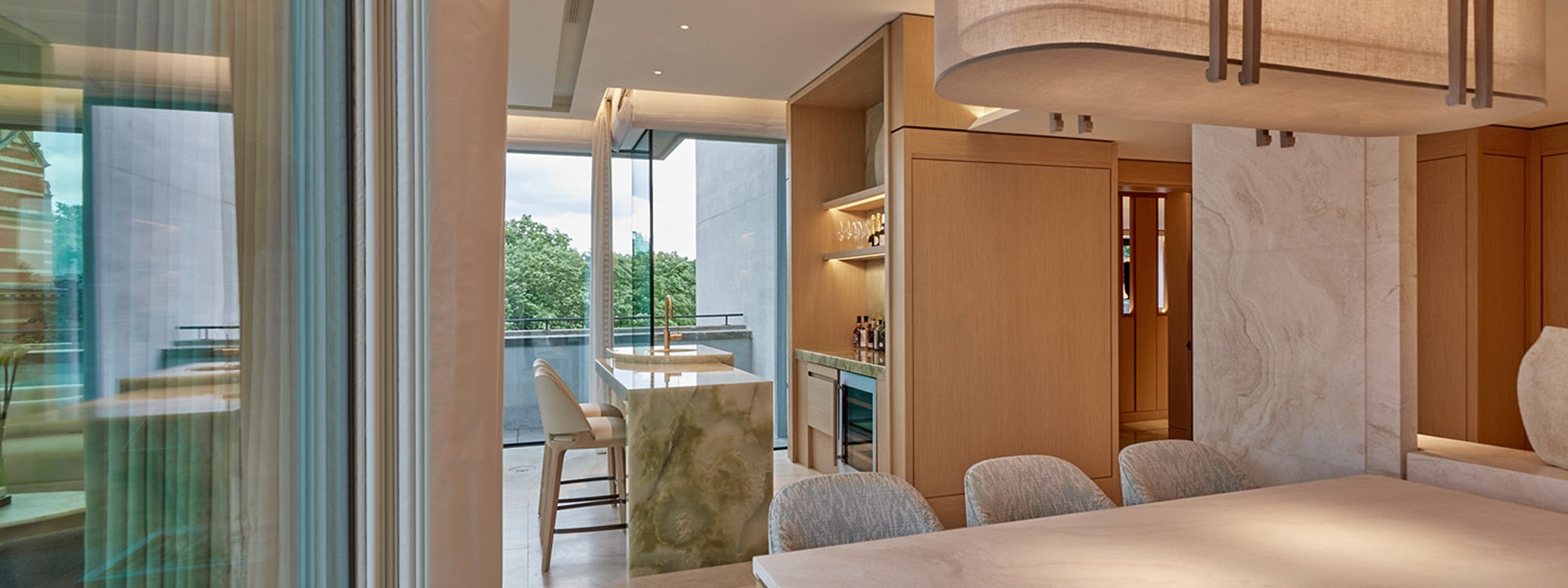 Knightsbridge Pavilion Penthouse - view of the kitchen with dining table in the foreground.