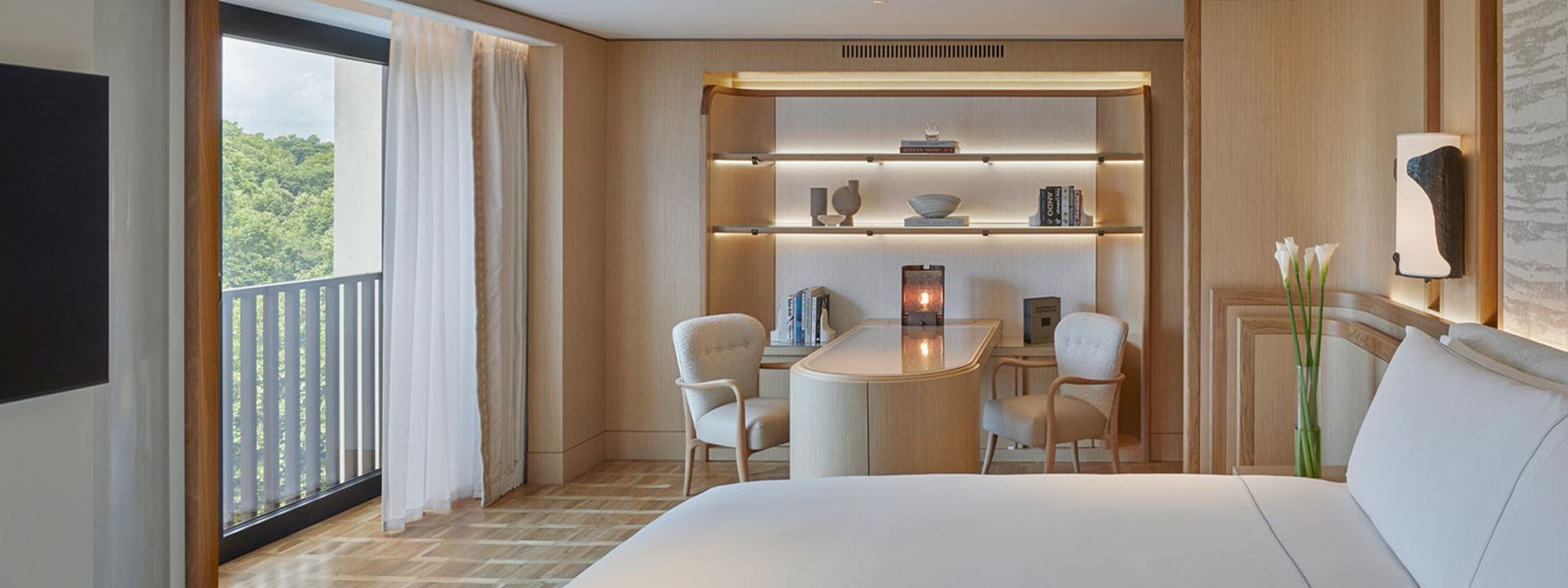 Knightsbridge Pavilion Penthouse - bedroom with bed, office area and shelves on the wall and window  on the left.