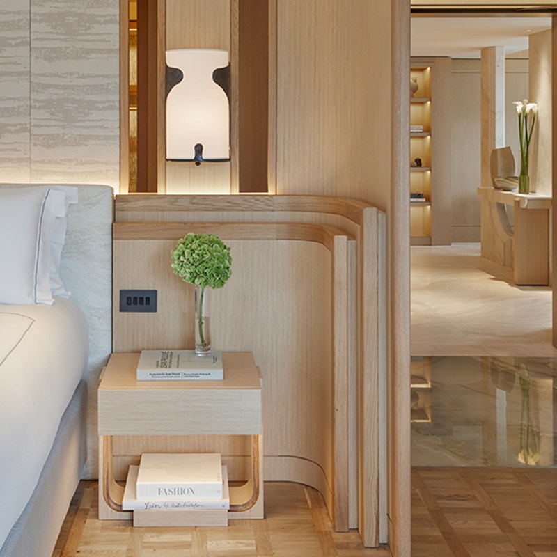 Knightsbridge Pavilion Penthouse at The Berkeley - detailed shot of the bedside table with flower in a vase on top of it and entrance of the room in the background.