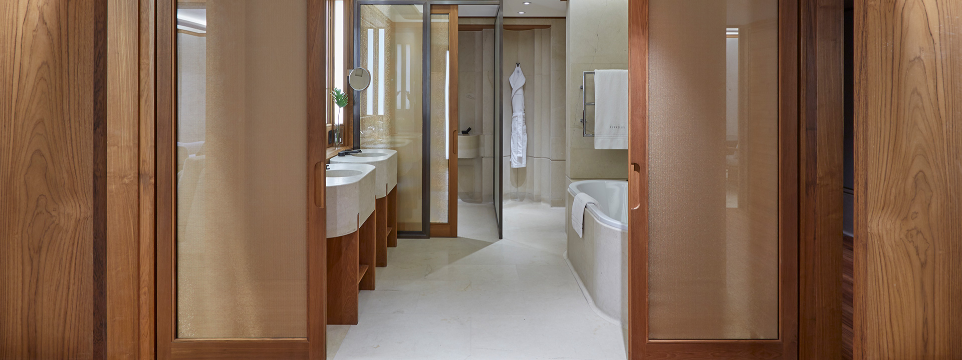 Contemporary bathroom with freestanding bathtub and walk-in shower in the Knightsbridge Suite.