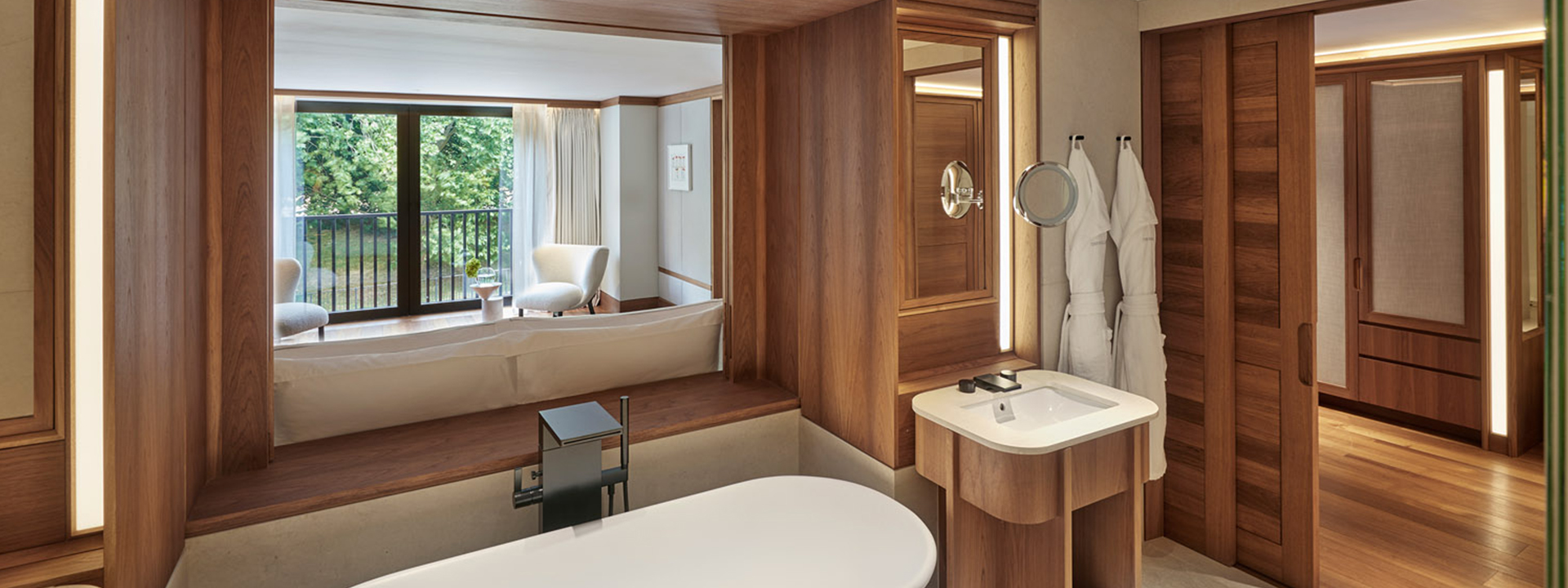 Park Suite at The Berkeley - bathroom view with bath and sinks and view onto the lounge behind the bathtub.