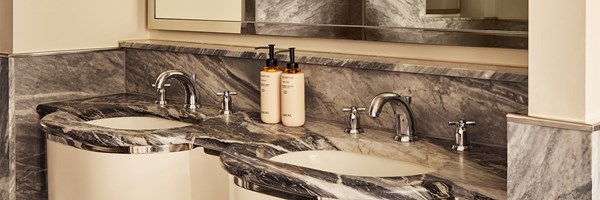 Bathroom vanity in the Terrace Junior Suite at The Berkeley with twin sinks, grey-veined marble surfaces, and luxury toiletries.