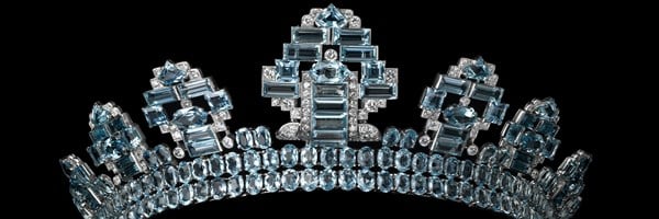 Art Deco tiara by Cartier featuring symmetrical towers of aquamarines and diamonds, with oval and baguette cuts set in platinum against a black background.