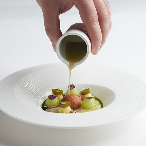A dish with sauce being poured on at Marcus at The Berkeley