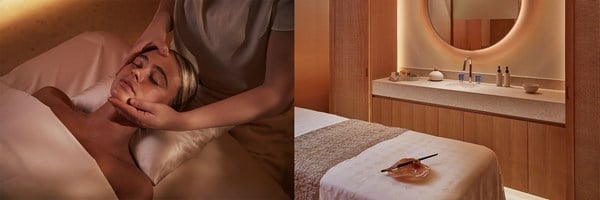 erson receiving a facial massage beside a warm, softly lit treatment room with a massage bed and round backlit mirror.