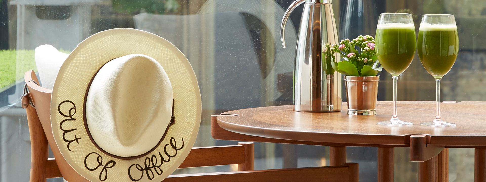 Display of one hat and two green smoothies in the interior of The Berkeley, for a bed and breakfast offer.